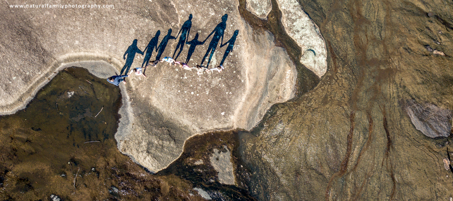 Alternative perspective family portrait featuring shadows and landscape. Natural Family Photography Melbourne